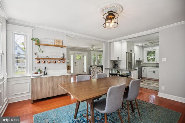a dining room with wooden floor and window