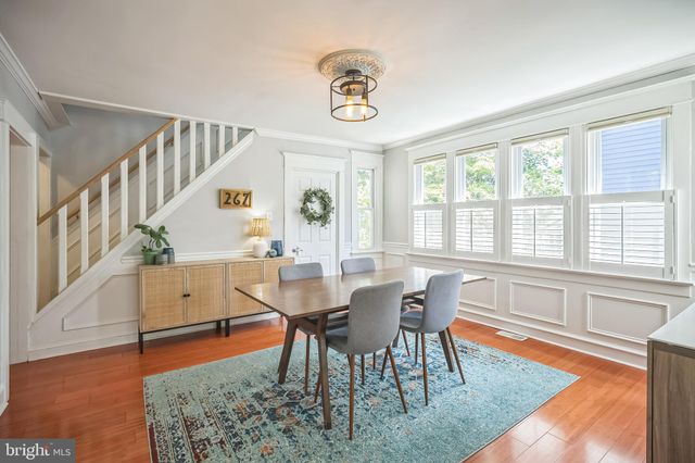 a view of a dining room with furniture a chandelier and wooden floor