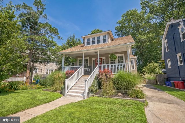 a view of house with a yard and potted plants