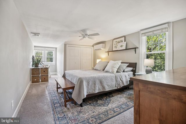 a bedroom with a large bed and a window