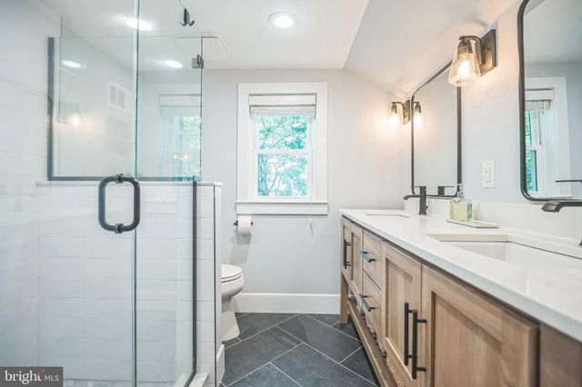 a bathroom with a shower a toilet and a sink