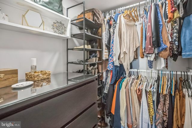 a en suite bathroom with a granite countertop sink and a mirror