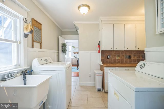 a utility room with cabinets washer and dryer