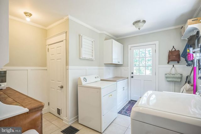 a patio with wooden floor a yard a table and chairs