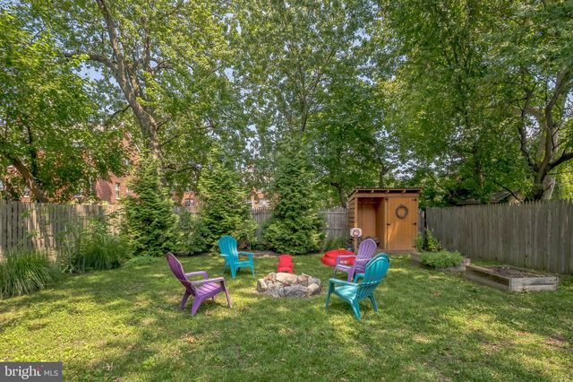 a view of a chairs and table in backyard of the house
