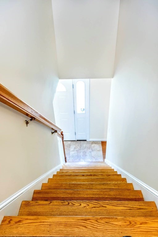 8 Spinney Path Lynn, MA 01902 - Photo 20 of 42 a bedroom with a bed and wooden floor