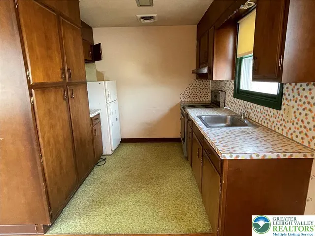 a bathroom with sink granite and a mirror