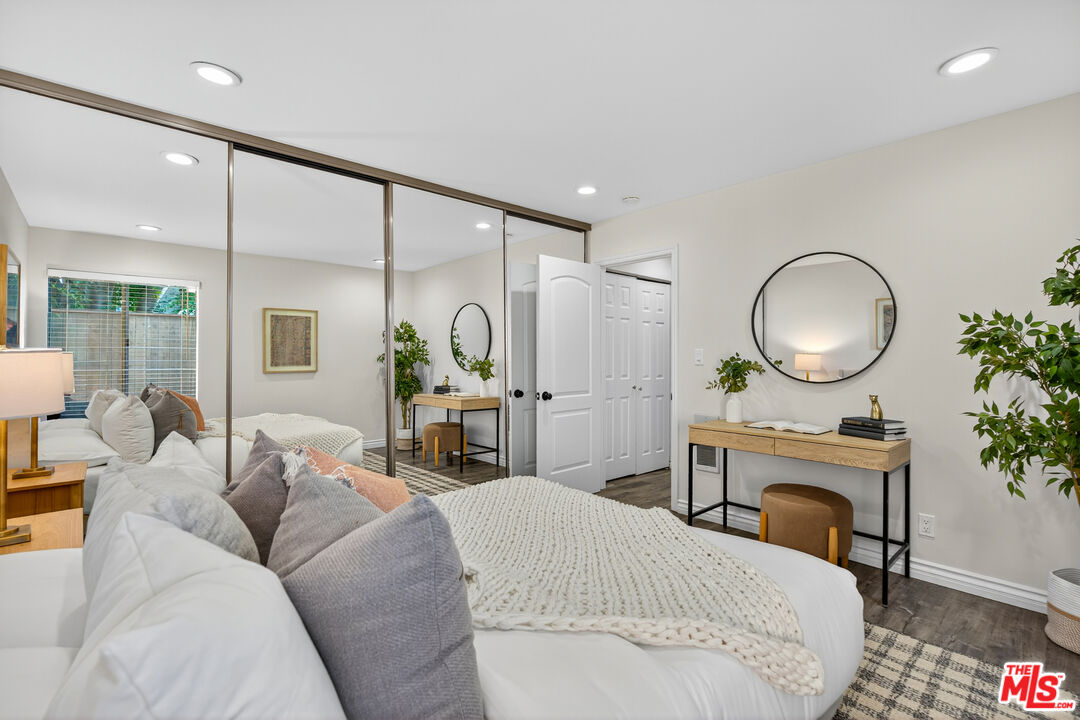1125 Pico Boulevard, Unit 103 Santa Monica, CA 90405 - Photo 17 of 33 a living room with furniture a mirror and a chandelier