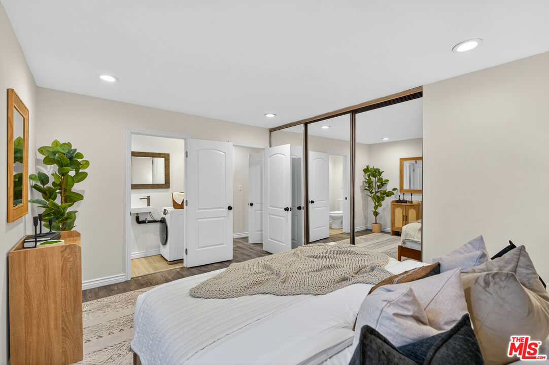 1125 Pico Boulevard, Unit 103 Santa Monica, CA 90405 - Photo 21 of 33 a bedroom with a bed and a potted plant