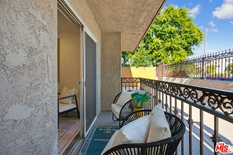 a view of balcony with furniture