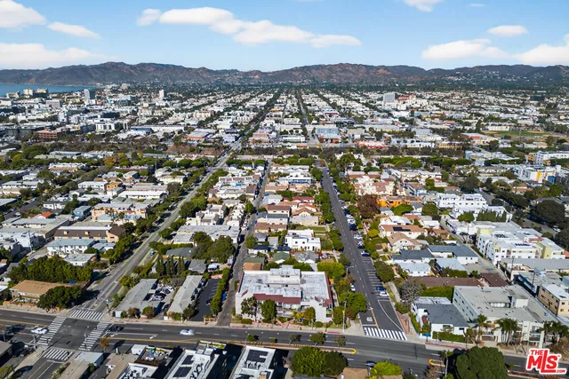 an aerial view of residential houses with city view