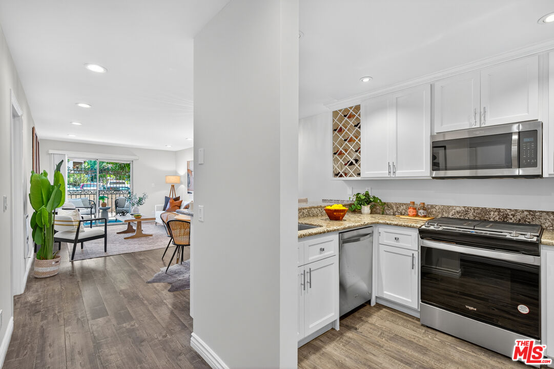 1125 Pico Boulevard, Unit 103 Santa Monica, CA 90405 - Photo 9 of 33 a kitchen with a sink a stove and cabinets