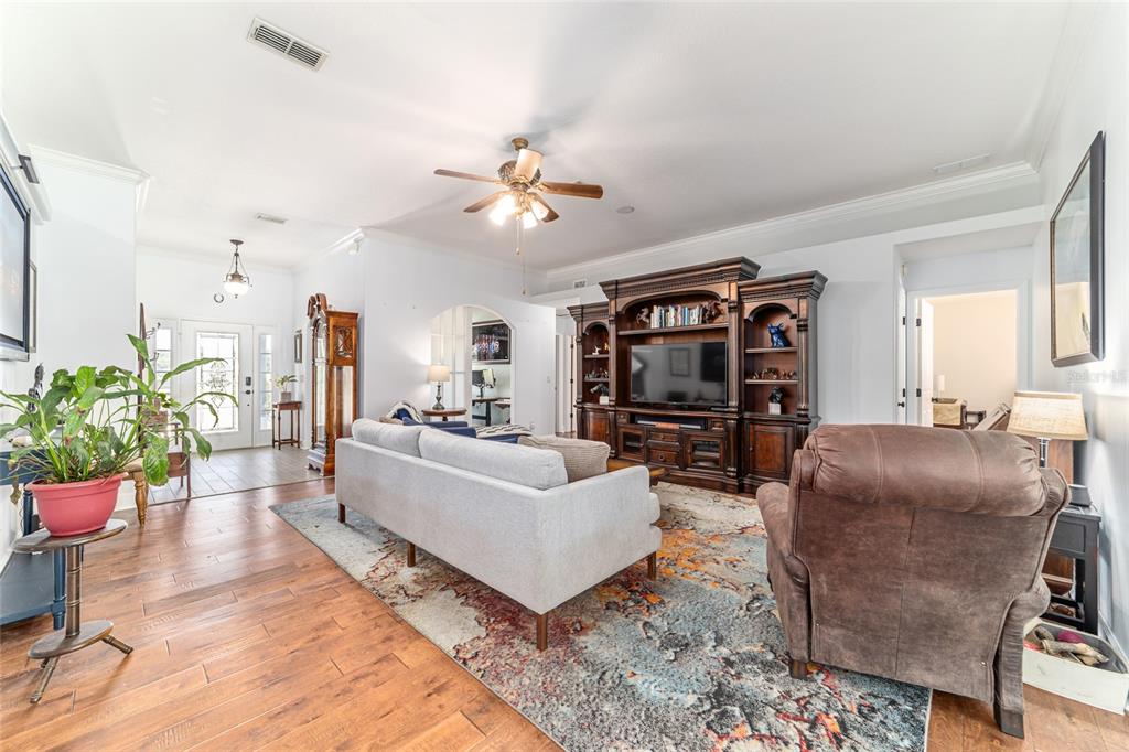 16050 Northwest 10th Circle Citra, FL 32113 - Photo 20 of 76 a living room with furniture a dining table and chairs with wooden floor