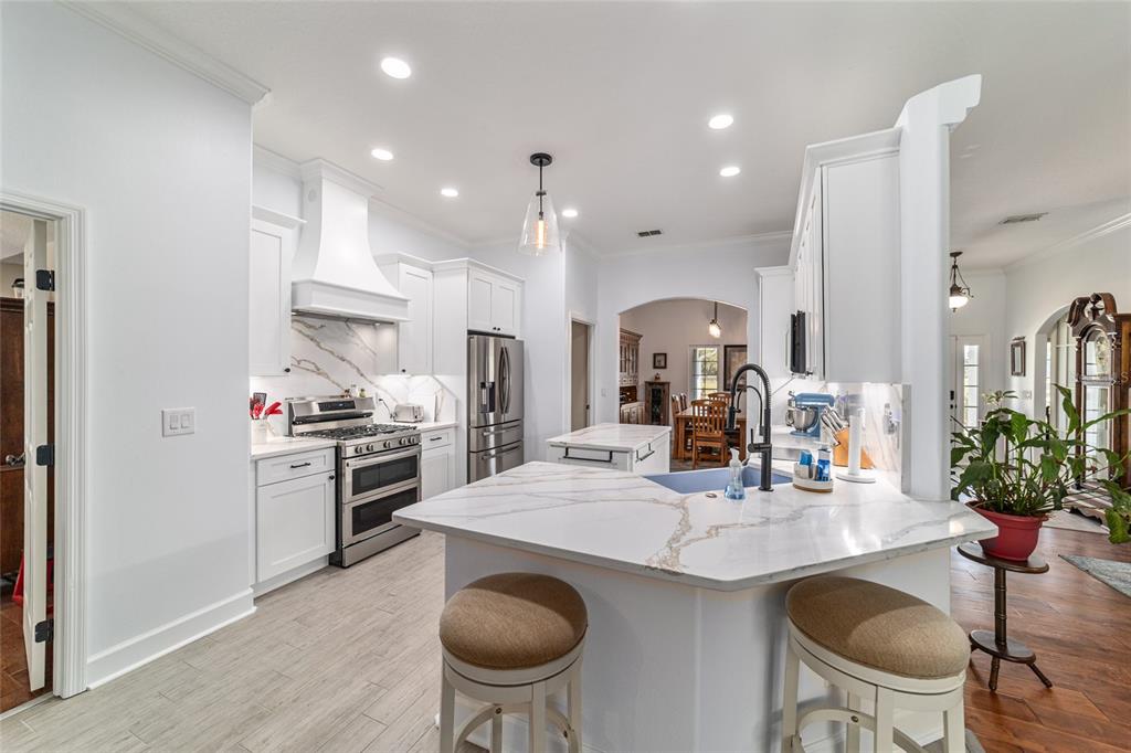 16050 Northwest 10th Circle Citra, FL 32113 - Photo 22 of 71 a kitchen with granite countertop a sink stove and refrigerator