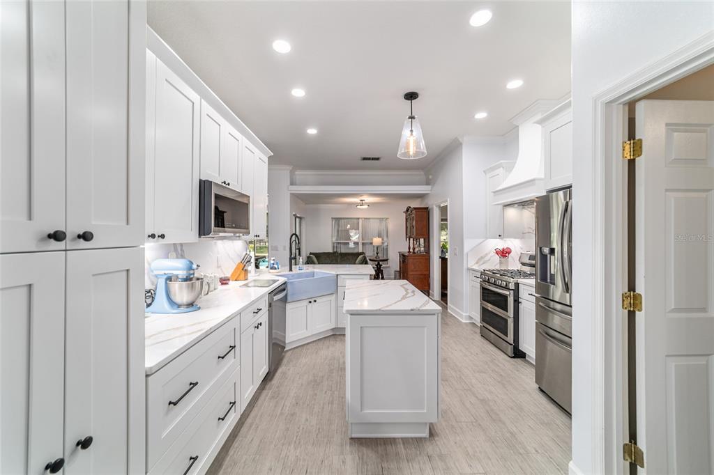 16050 Northwest 10th Circle Citra, FL 32113 - Photo 25 of 71 a kitchen with white cabinets and stainless steel appliances