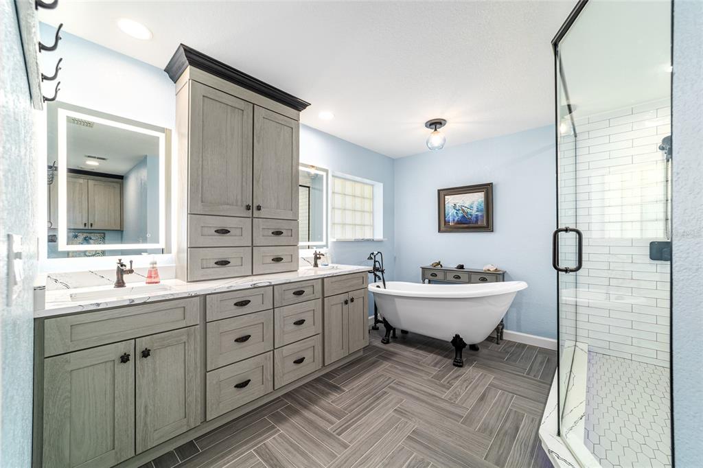 16050 Northwest 10th Circle Citra, FL 32113 - Photo 37 of 71 a bathroom with a double vanity sink mirror bathtub and toilet
