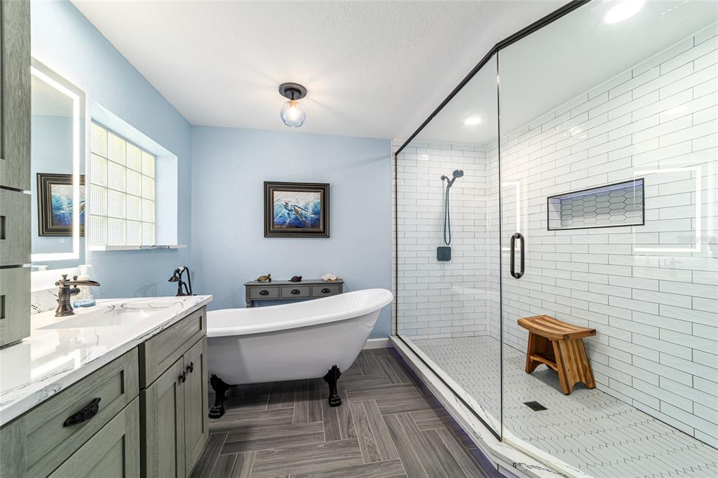 16050 Northwest 10th Circle Citra, FL 32113 - Photo 38 of 71 a bathroom with a double vanity sink a mirror and a bathtub