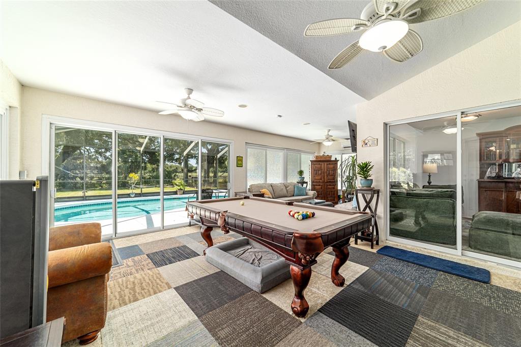 16050 Northwest 10th Circle Citra, FL 32113 - Photo 49 of 76 a view of a dining room with furniture wooden floor and chandelier