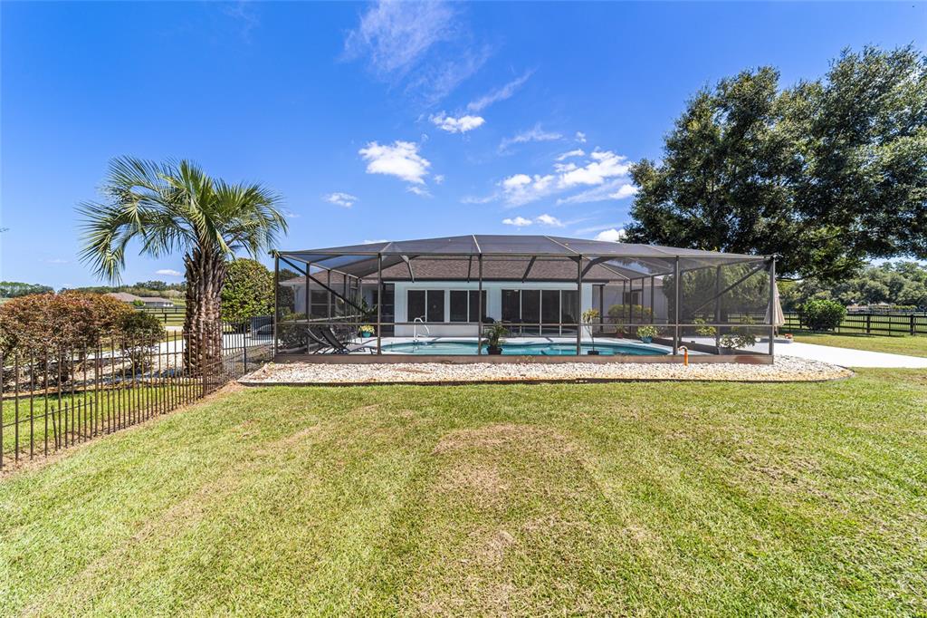 16050 Northwest 10th Circle Citra, FL 32113 - Photo 55 of 71 a view of swimming pool with outdoor seating and house in the background