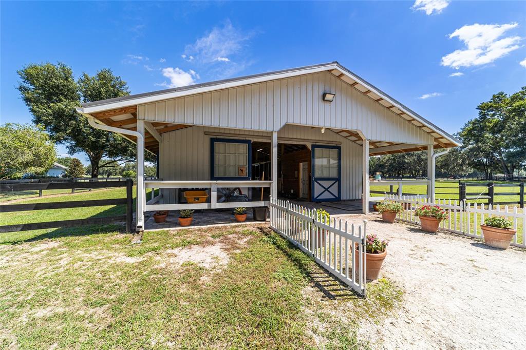 16050 Northwest 10th Circle Citra, FL 32113 - Photo 59 of 76 a view of a house with a big yard potted plants and large tree