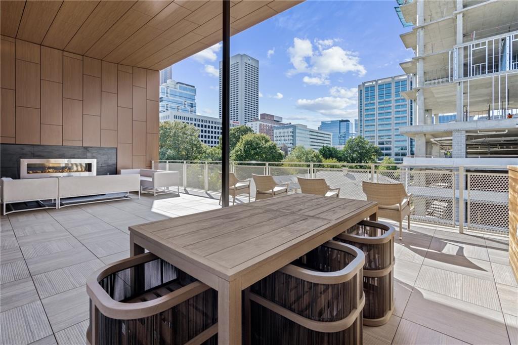 775 Juniper Street Northeast, Unit 227 Atlanta, GA 30308 - Photo 37 of 42 a bath room with a table chairs and a kitchen view