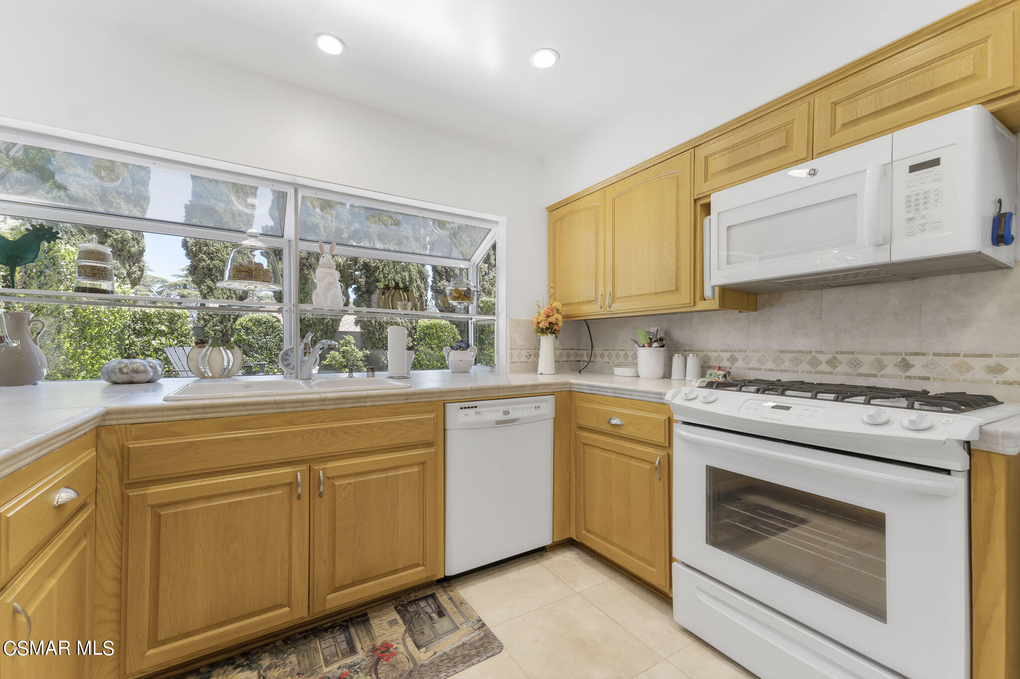 2516 Clearfield Place Simi Valley, CA 93065 - Photo 12 of 39 a kitchen with white cabinets and white appliances