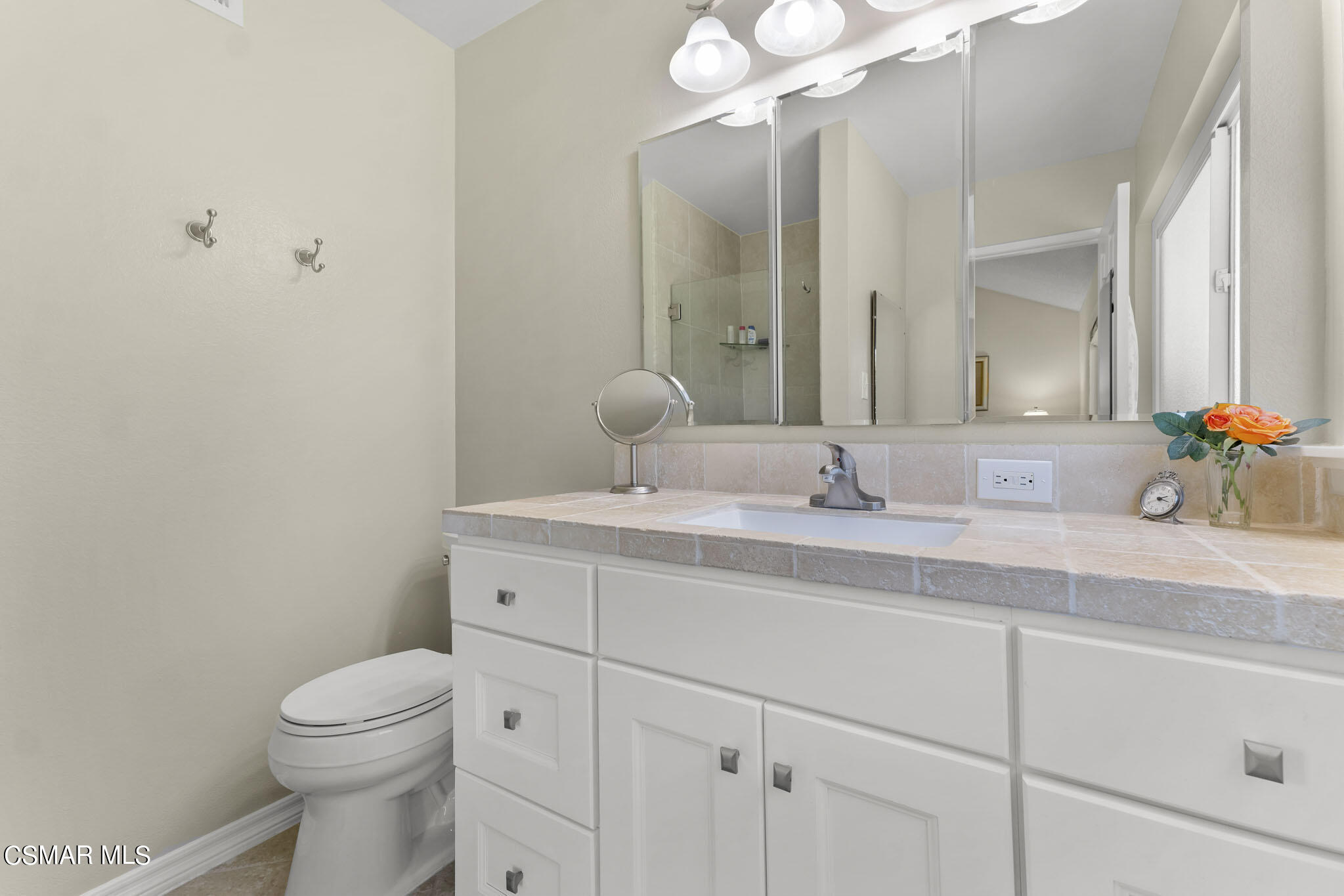 2516 Clearfield Place Simi Valley, CA 93065 - Photo 20 of 39 a bathroom with a granite countertop sink a toilet and a mirror