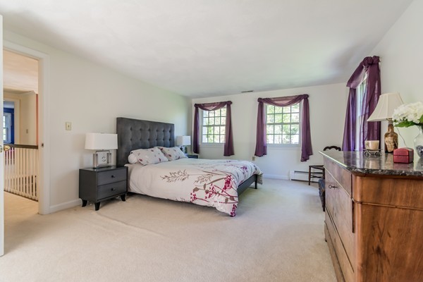 22 Blueberry Hill Road Andover, MA 01810 - Photo 14 of 30 a spacious bedroom with a bed couch and windows