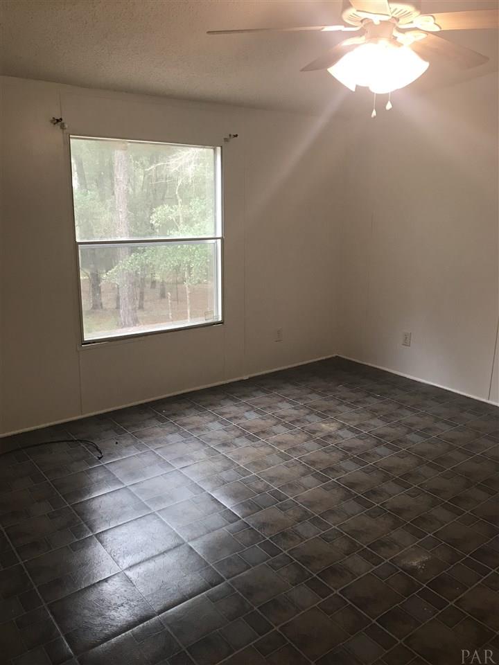 1176 Country Living Road Baker, FL 32531 - Photo 10 of 27 an empty room with a window