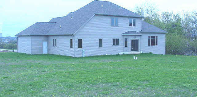 4382 Ridgeview Lane Byron, IL 61010 - Photo 5 of 5 a front view of a house with a garden