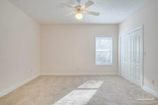 a bathroom with a granite countertop double vanity sink and a mirror