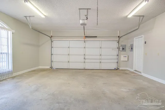a view of a house with a yard and a garage