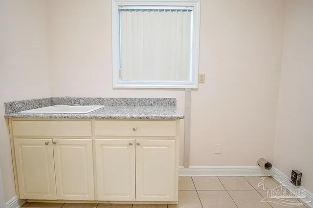 a bathroom with a sink and cabinets