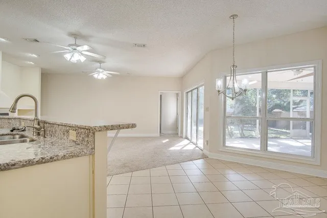 a view of a kitchen with a sink cabinets and outdoor space