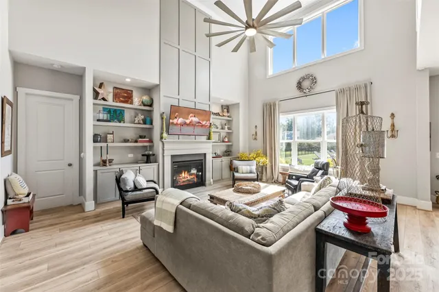 a living room with furniture a fireplace and a window