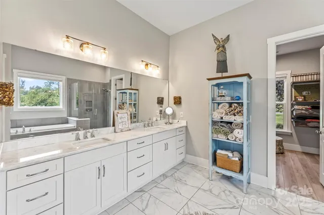 a spacious bathroom with a granite countertop sink mirror and vanity