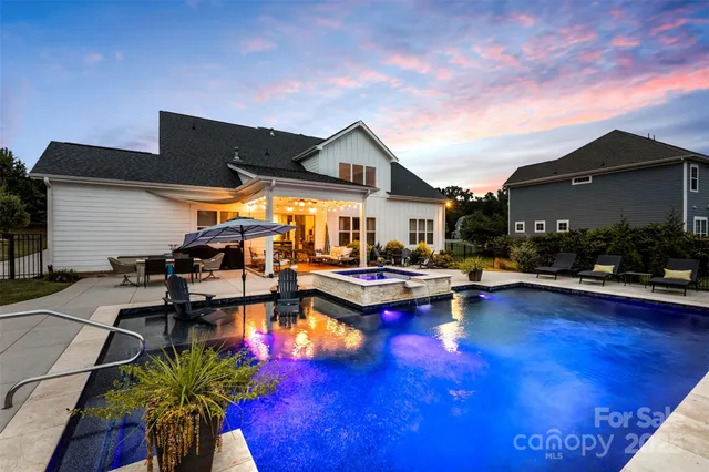 a view of swimming pool with outdoor seating and wooden floor