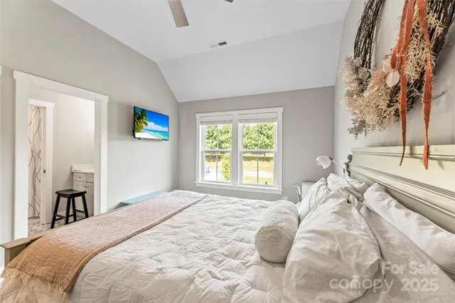 a bedroom with a bed and a painting on the wall