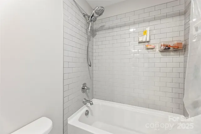 a bathroom with a bathtub and shower