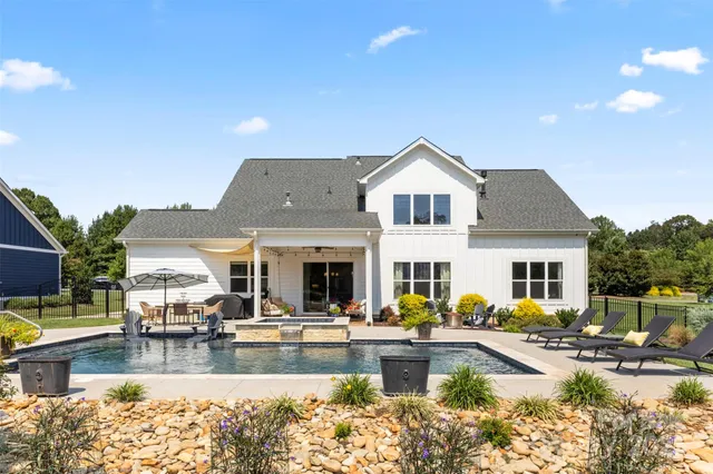 a view of a swimming pool with outdoor seating
