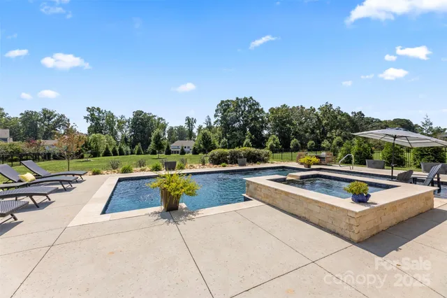 a view of swimming pool with chairs