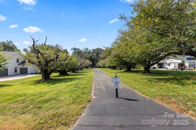 an aerial view of a house with a swimming pool patio and outdoor seating