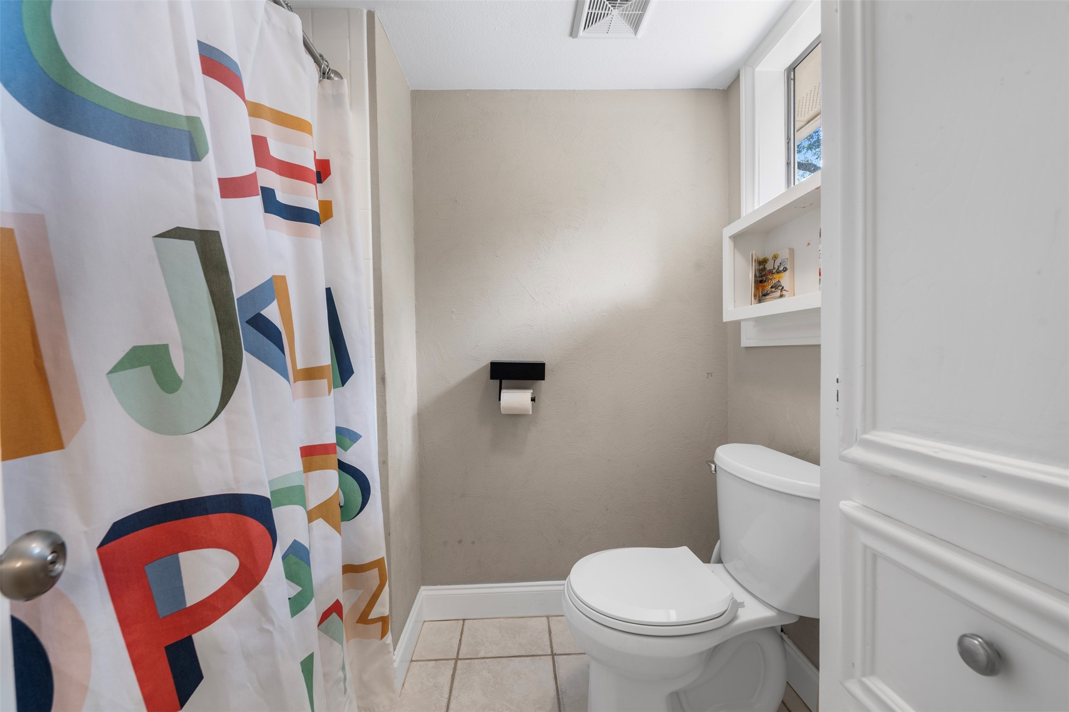 4223 Annawood Circle Spring, TX 77388 - Photo 15 of 30 a white toilet sitting next to a bathroom sink and a mirror