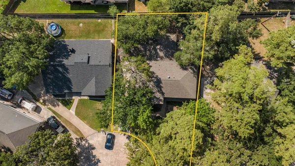 an aerial view of a house with a yard and lake view