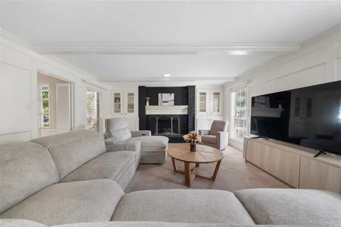 a living room with fireplace furniture and a flat screen tv