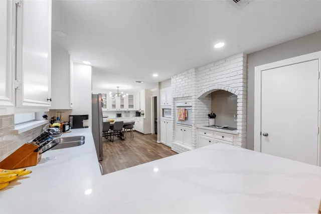 a large bedroom with a bed and a large window