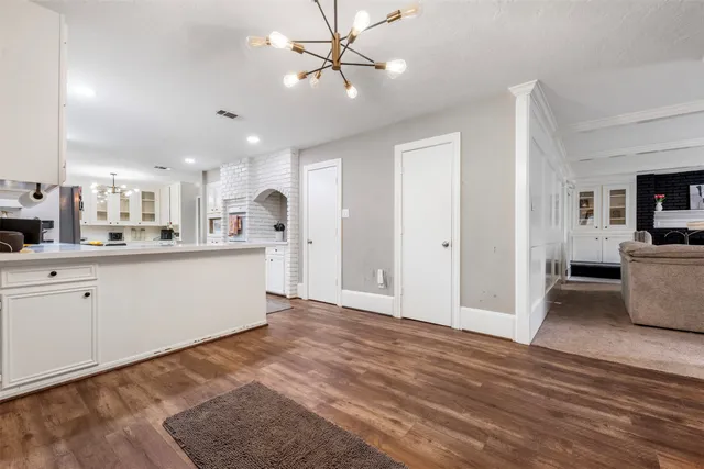a view of kitchen with granite countertop cabinets and white appliances