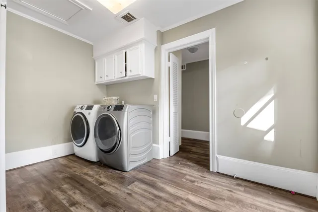 a utility room with sink dryer and washer