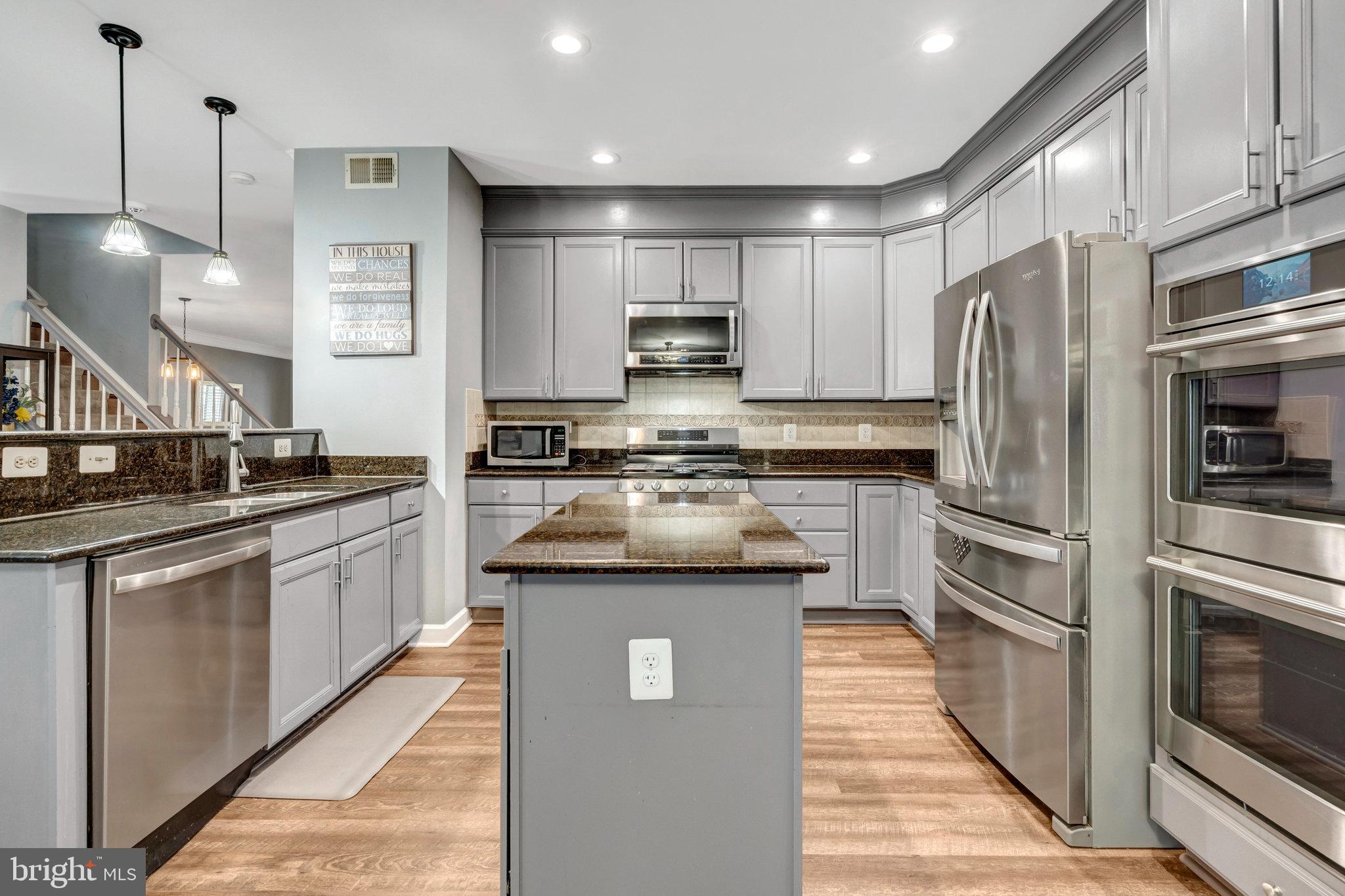 4169 Agency Loop Triangle, VA 22172 - Photo 13 of 56 Sleek modern kitchen with elegant finishes.