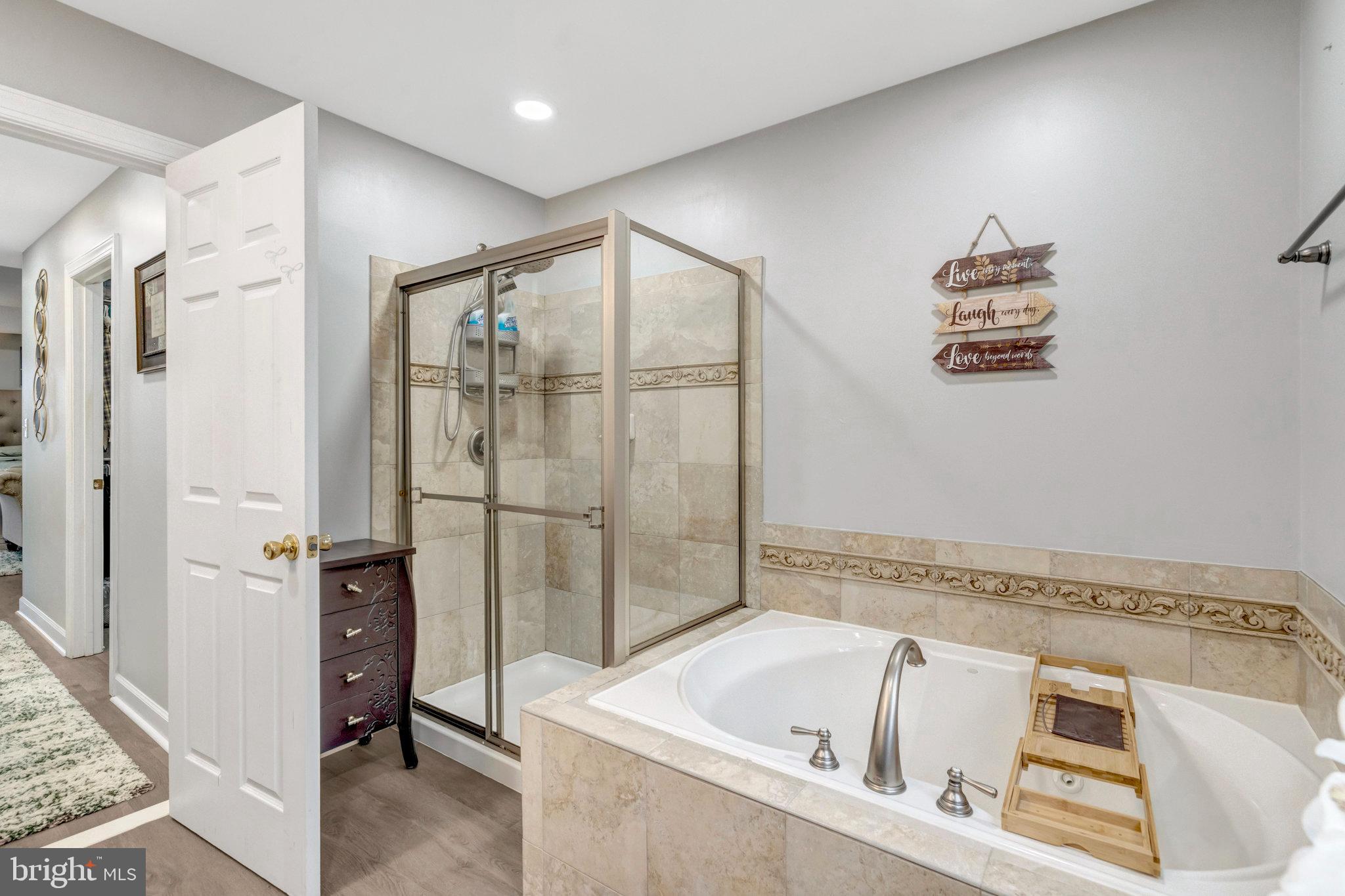 4169 Agency Loop Triangle, VA 22172 - Photo 28 of 56 a bathroom with a tub a sink and a shower